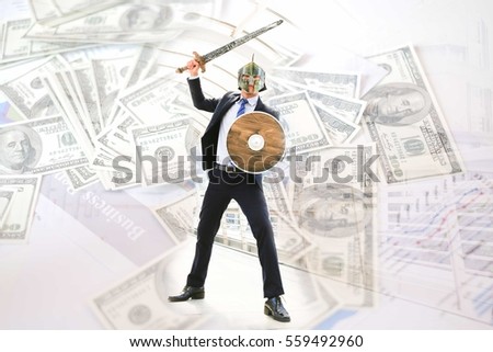 Businessman wearing knight suit prepare to fight for money,fighting for money concept.
Business attack concept.