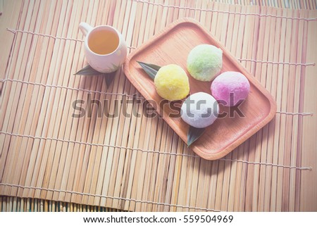Mo chi dessert,stuffed eggs on bamboo with tea cup and blank copy space notebook