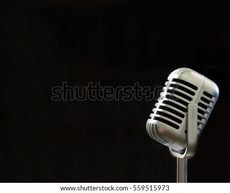 Vintage microphone voice speaker on black background and copy space