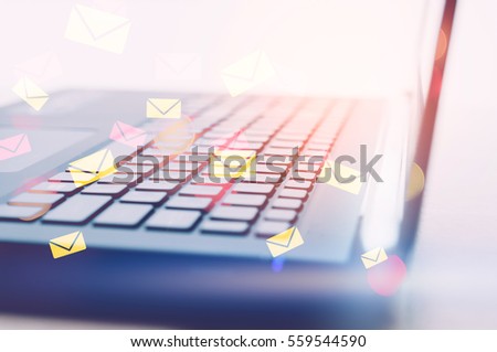 Business economic and technology working concept. Close up keyboard notebook window light double exposure colorful email draw graphic bokeh background. Vintage tone filter effect color style.