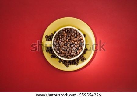 Modern coffee concept. Coffee cup with coffee beans. Top view.