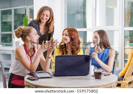 Group of four pretty businesswoman working together with new startup project using laptop computer in modern loft. People and teamwork concept - happy creative team in office. Women in business. Royalty-Free Stock Photo #559575802