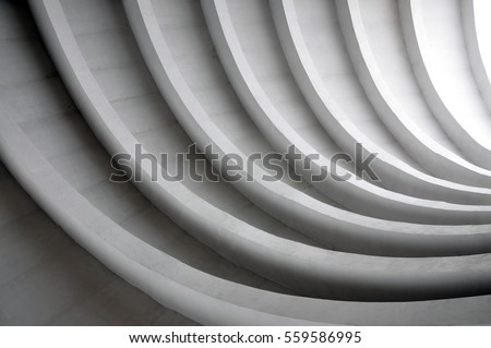 Architectural background. Modern white concrete arched composition in perspective. Semicircular shapes. The light in the end.