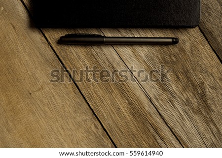 wooden table with notebook and pen. top view with copy space,flat lay.