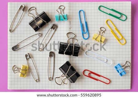 Pins and paper clips collection, pink background