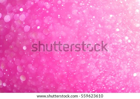 abstract bokeh circles on pink background for valentines day, glitter light de-focused and blurred bokeh