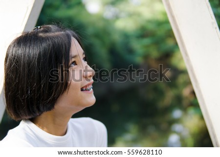 Asian teenage short hair wear white shirt in the park
