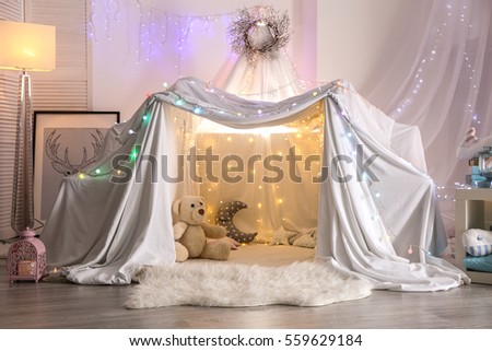 Hovel decorated with garland for children's party at home