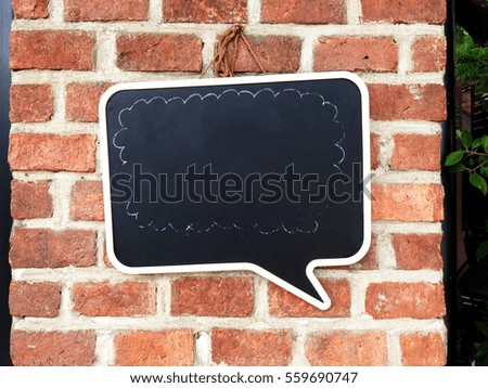 Blank sign hanging on brick wall.Empty signage.
