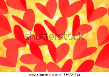 Valentine day concept, red paper in heart shape with gold glitter as background
