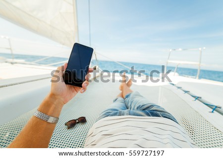 Rest on a yacht in the first person. Feet first person Royalty-Free Stock Photo #559727197