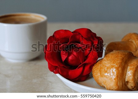 Cup of coffee, croissants and rose on table, romantic breakfast, Valentine Concept
