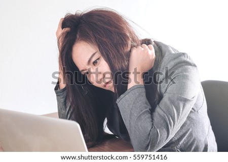 Business image of a stress businesswoman working on laptop with white background office