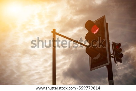 Traffic light at the intersection of the evening at sunset.