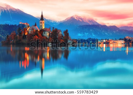 Night scene of Bled lake in Slovenia, famous and popular travel destination for romantic couple in love. Artistic toning landscape. Fantasy post processing. Royalty-Free Stock Photo #559783429