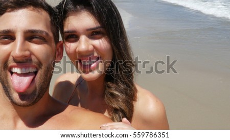 Couple taking a selfie in the beach