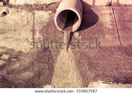 Concrete circular pipe discharging water to a canal