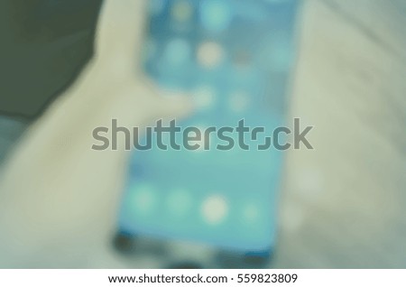 Blurred abstract background and can be illustration to article of hand use smartphone