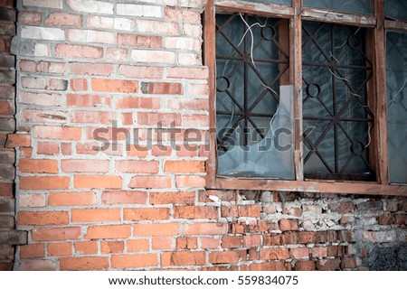 Broken window in the brick building