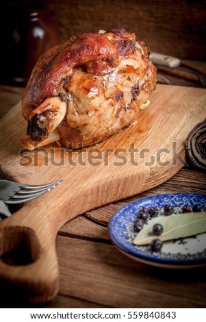 Roast pork knuckle on a wooden board. Selective focus.