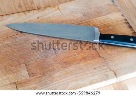 empty chopping board for food preparation with knife