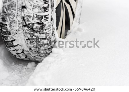 Winter tires closeup. Car in the snow.