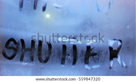 SHUTTER: word written on the misted glass of the window