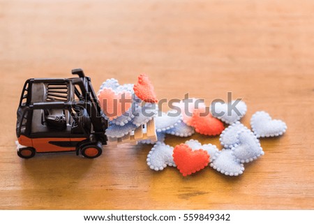 Love and Valentine day Concept. Forklift truck machine toy with heart shape cloths