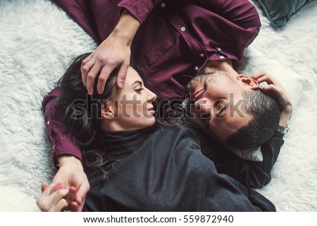 Man and woman embracing in bed. Close-up. Royalty-Free Stock Photo #559872940