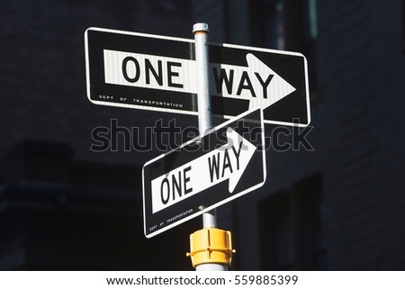 Close up of one way signs on street