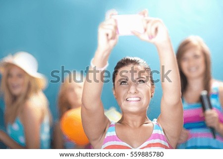 Girl taking picture with cell phone
