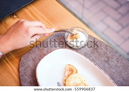Cheese pancakes on white plate at restaurant. Selective focus.