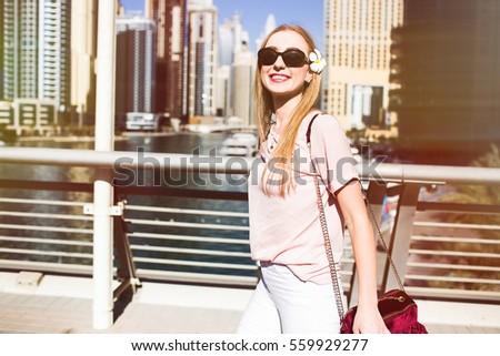 Sunny picture of cheerful lady posing on bridge somewhere in Dubai