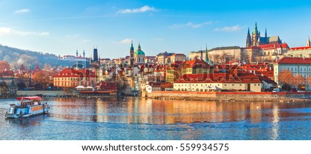 Old town of Prague. Czech Republic over river Vltava with Saint Vitus cathedral on skyline. Bright sunny day blue sky. Praha panorama landscape view. Royalty-Free Stock Photo #559934575