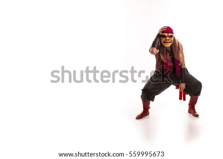 actor man in a pirate costume with a scary mask on his face jumping and dancing on a white background. character for a computer game.