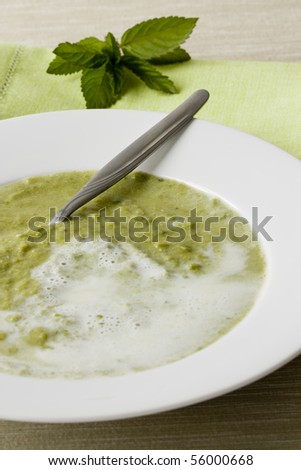 Selective focus image of a peas soup made with mint.