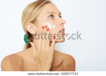 Woman cleaning her face. Beautiful young woman with clear-up patches or plaster on her nose looking at camera. Skin care concept. Beauty and healthcare