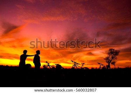colorful of family cyclist and Bicycle silhouettes on the dark background of sunsets 