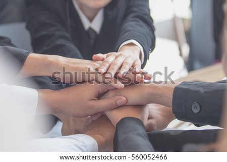 Concept of teamwork. business people joined hands Royalty-Free Stock Photo #560052466