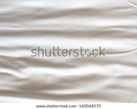 folded white bed sheet Royalty-Free Stock Photo #560068570