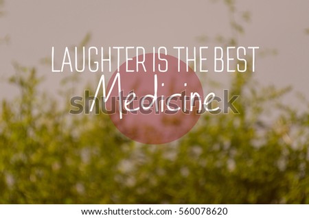 "Laughter is the best medicine" text on blurry green nature background. Positive message.