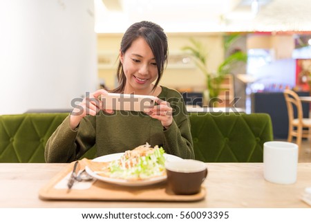 Woman taking photo before enjoy her salad