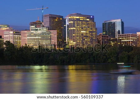 City suburb near Potomac River at dawn in Washington DC, USA. Urban skyline with colorful reflections before the sunrise.