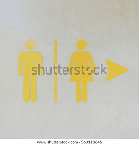 Toilet sign on mortar wall - soft light warm tone - square shaped