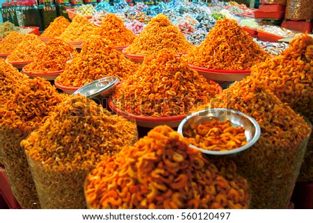 Mounts of spices yellow orange curry cumin dried food prawn shrimp scenes of daily life along streets of South East Asia city Vietnam commuting street vendors food stall heavy traffic