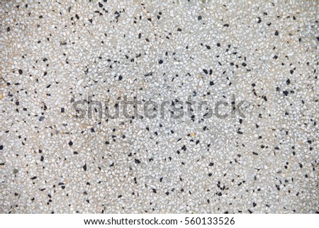 Cement mixed small gravel stone wall or floor texture background,The Dust Texture. Abstract dense splash texture. Random pebble gravel oval elements seamless pattern.