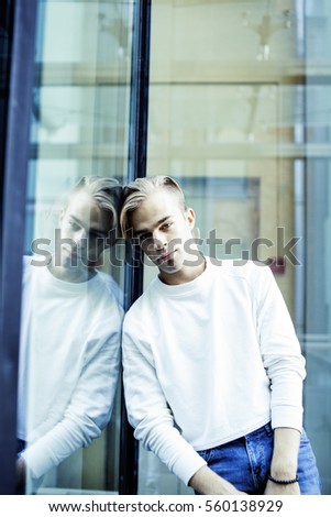 young modern hipster guy at new building university blond fashion hairstyle having fun, lifestyle people concept