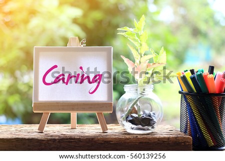 CARING - concept of sweet words words on the canvas with natural background