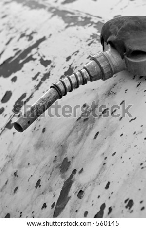 old and heavily used gas nozzle on a large rusting steel drum - converted to black and white, color version also available