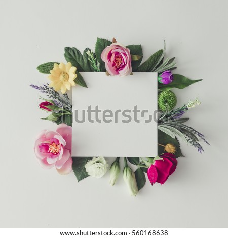 Creative layout with colorful flowers, leaves and copy space card note. Nature concept. Flat lay.